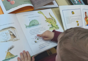 Dzieci wyszukują w książakch informacji dotyczących planety Ziemi